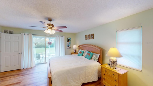 bedroom with a textured ceiling, access to outside, ceiling fan, and light hardwood / wood-style floors