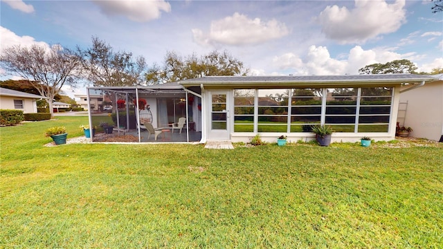 rear view of house featuring a yard