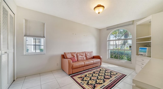 living area featuring plenty of natural light and light tile flooring