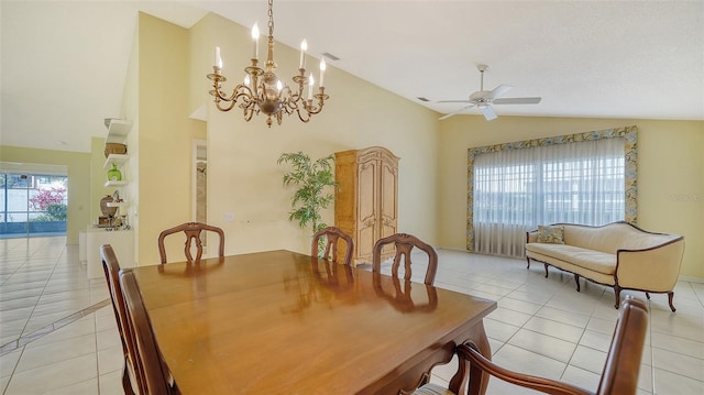 dining area with ceiling fan with notable chandelier, vaulted ceiling, and light tile floors