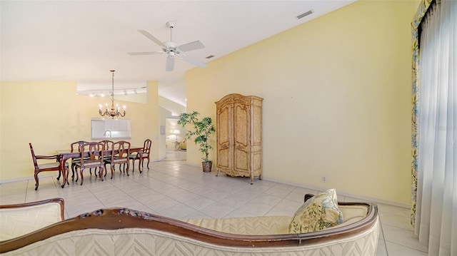 interior space with ceiling fan with notable chandelier, light tile floors, and lofted ceiling