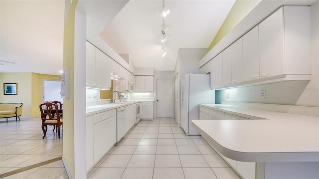 kitchen featuring white cabinets, light tile floors, rail lighting, and white appliances