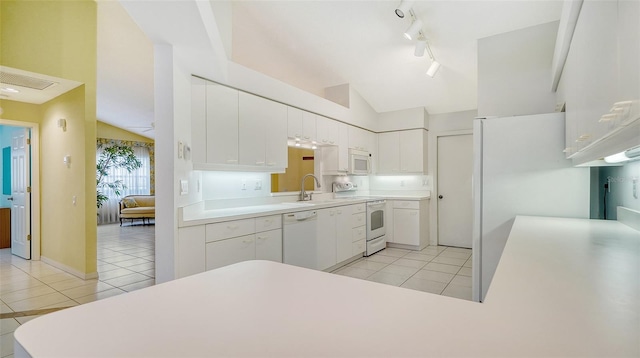 kitchen featuring light tile floors, vaulted ceiling, white appliances, white cabinetry, and track lighting