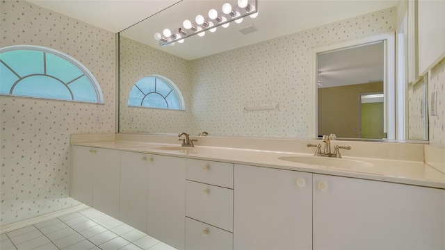 bathroom featuring tile floors and dual vanity