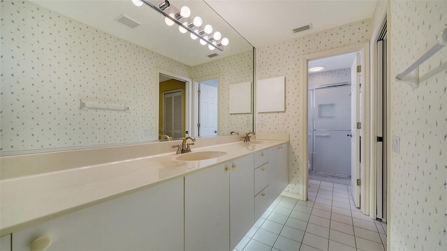 bathroom featuring a chandelier, dual vanity, and tile flooring