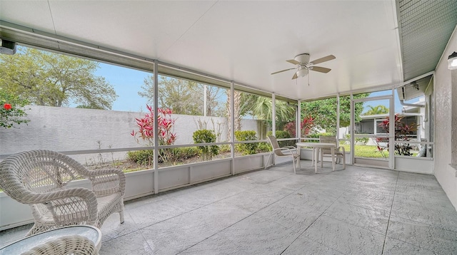 unfurnished sunroom with ceiling fan