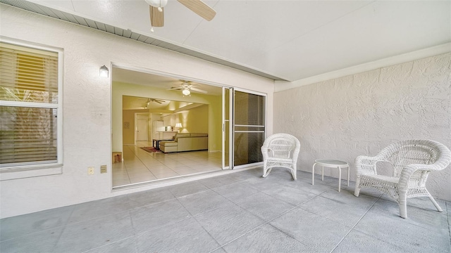 interior space with ceiling fan