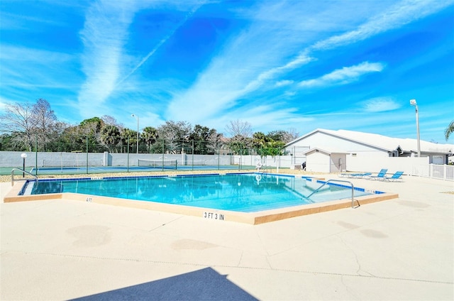 view of swimming pool with a patio area