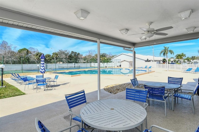 view of patio featuring a community pool and ceiling fan