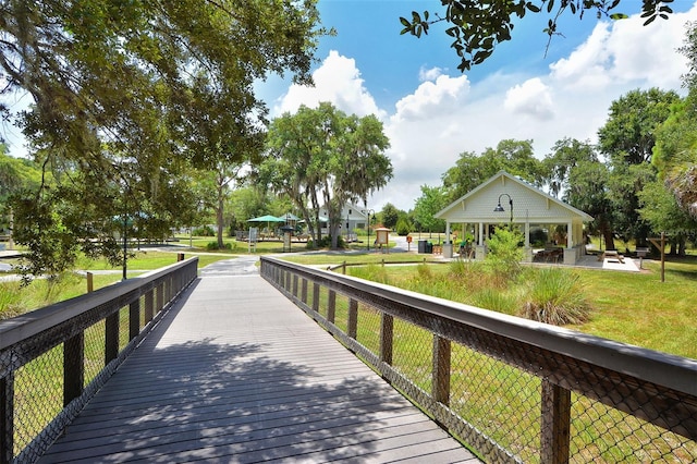 view of dock with a lawn