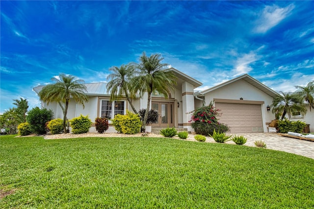 ranch-style house featuring a front lawn and a garage