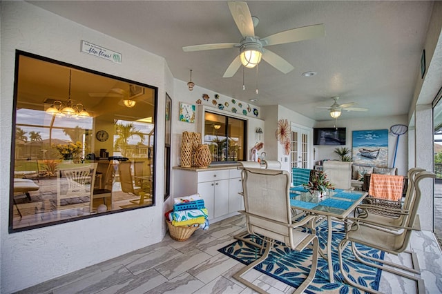 interior space with ceiling fan