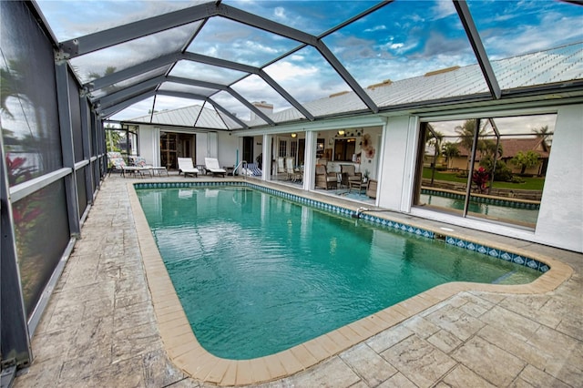 view of swimming pool with a lanai and a patio area