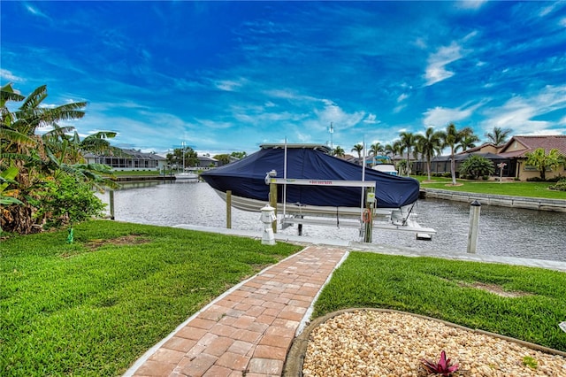 view of dock with a lawn and a water view