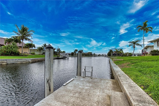 view of dock featuring a lawn and a water view