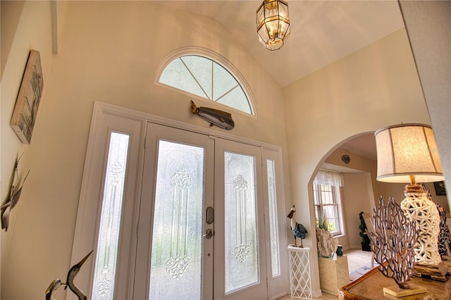 entrance foyer featuring french doors and high vaulted ceiling