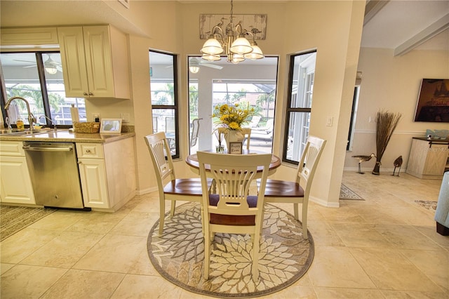 dining area featuring ceiling fan with notable chandelier, sink, and light tile floors