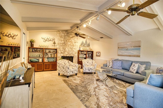 tiled living room with rail lighting, a fireplace, ceiling fan, and vaulted ceiling with beams