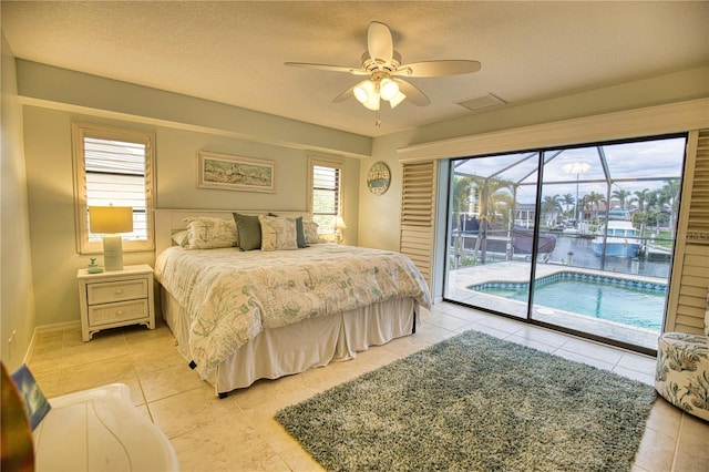 tiled bedroom featuring access to outside, ceiling fan, and a textured ceiling