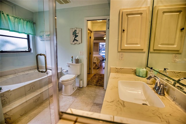 bathroom featuring toilet, vanity, tile patterned flooring, and a bath