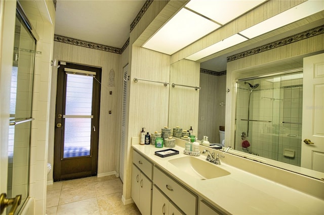 bathroom with tile floors, vanity with extensive cabinet space, and toilet