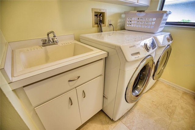 clothes washing area with washer hookup, sink, light tile flooring, cabinets, and separate washer and dryer