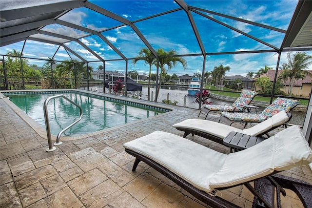 view of pool with a patio area, a water view, and a lanai