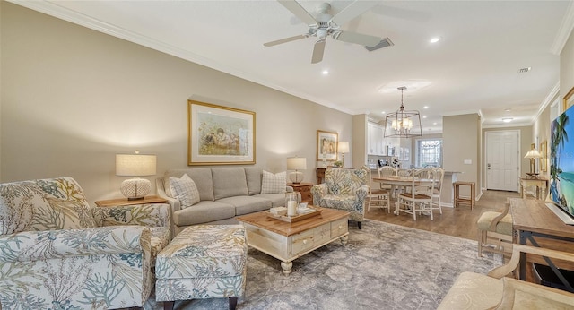 living room featuring ornamental molding, ceiling fan with notable chandelier, and dark hardwood / wood-style flooring