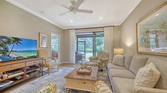 living room with ceiling fan, ornamental molding, and light hardwood / wood-style flooring