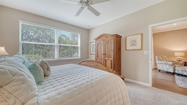 bedroom with light carpet and ceiling fan