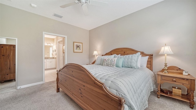 tiled bedroom with ceiling fan and ensuite bathroom