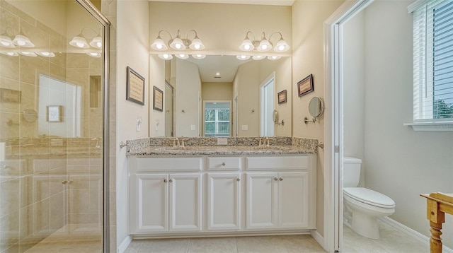 bathroom featuring walk in shower, dual sinks, tile flooring, vanity with extensive cabinet space, and toilet