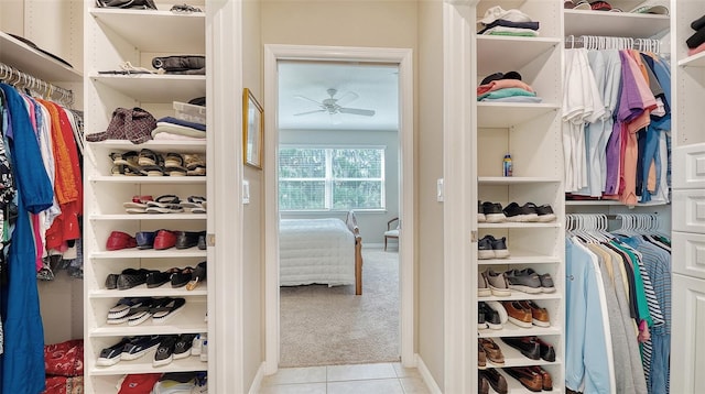 spacious closet featuring light carpet and ceiling fan