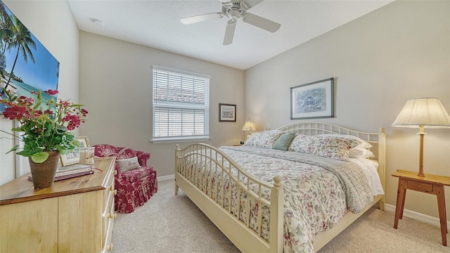 bedroom featuring light colored carpet and ceiling fan