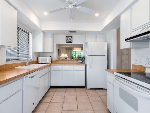 kitchen with ceiling fan, sink, white appliances, light tile flooring, and white cabinetry