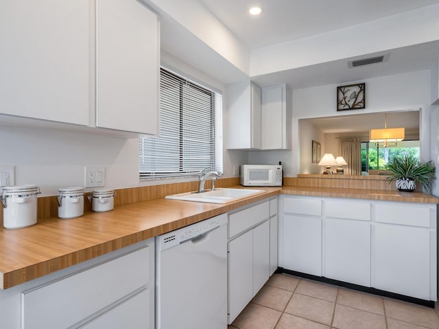 kitchen with white cabinets, white appliances, and sink