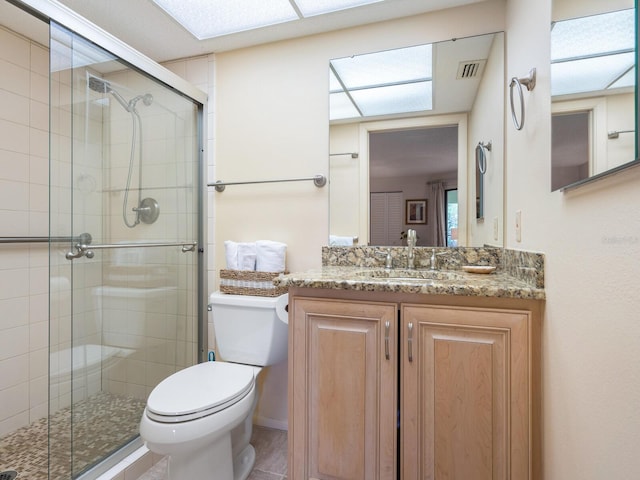 bathroom with walk in shower, oversized vanity, toilet, and tile flooring