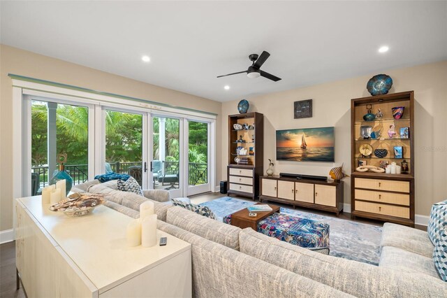 living room featuring ceiling fan, dark hardwood / wood-style flooring, and french doors