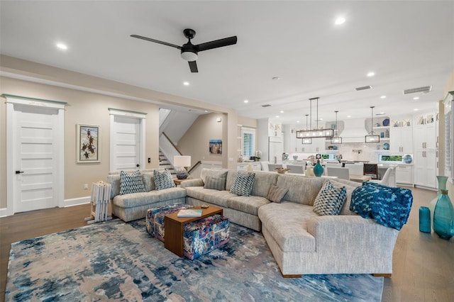 living room with dark hardwood / wood-style floors and ceiling fan