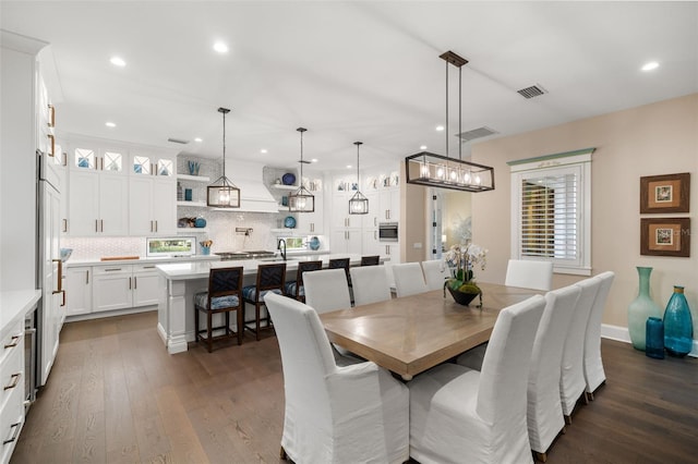 dining area featuring dark wood-type flooring