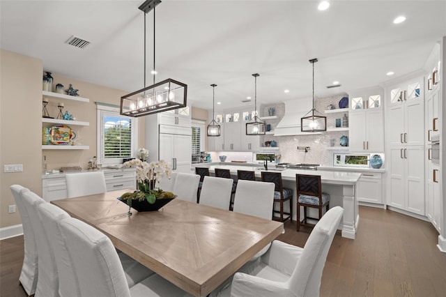 dining space with dark hardwood / wood-style flooring