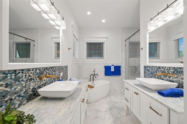 bathroom featuring independent shower and bath and vanity