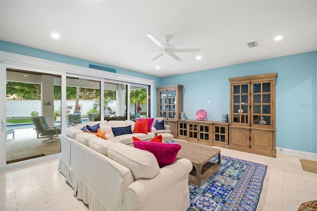 living room with ceiling fan and light tile patterned floors