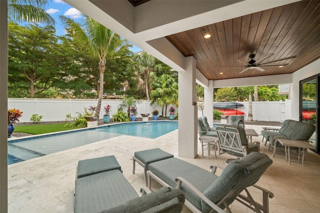 view of pool with a patio and ceiling fan