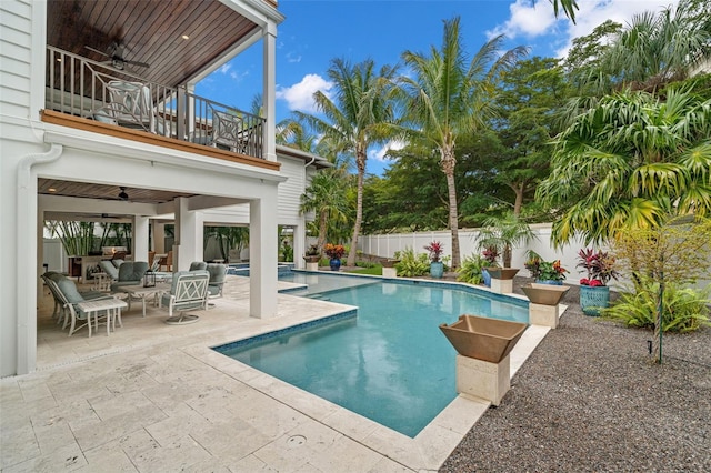 view of swimming pool featuring ceiling fan, outdoor lounge area, and a patio area