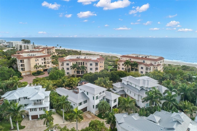 drone / aerial view with a water view and a beach view