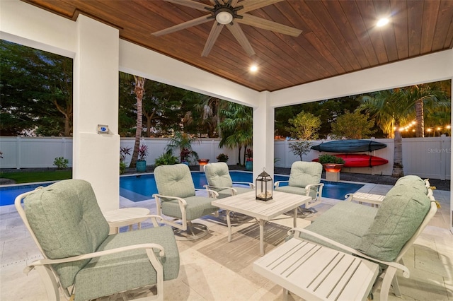 view of patio featuring a swimming pool with hot tub and ceiling fan