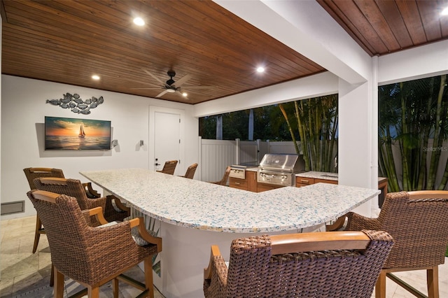 interior space featuring wooden ceiling and ceiling fan