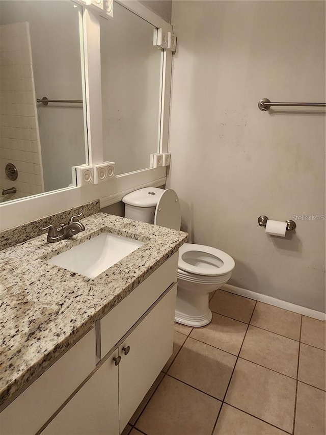 bathroom featuring toilet, tile flooring, and vanity