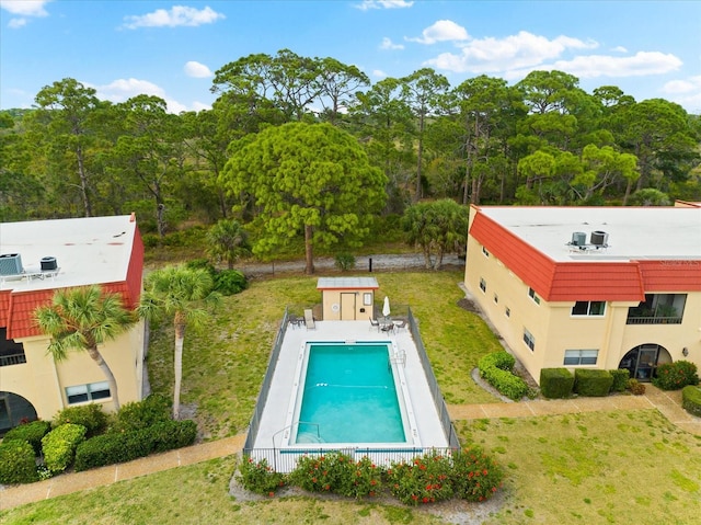 view of pool featuring a yard